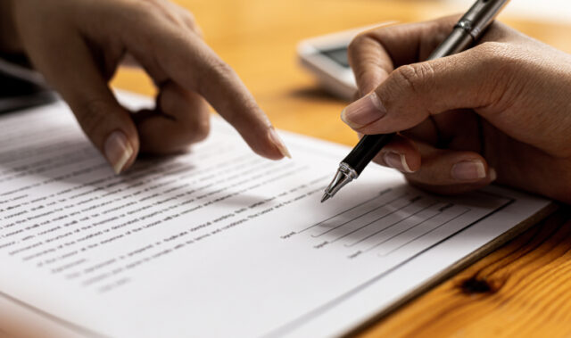 person signing a document