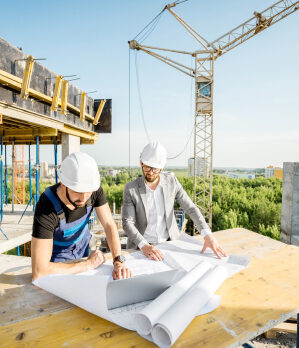 construction workers reviewing blueprints