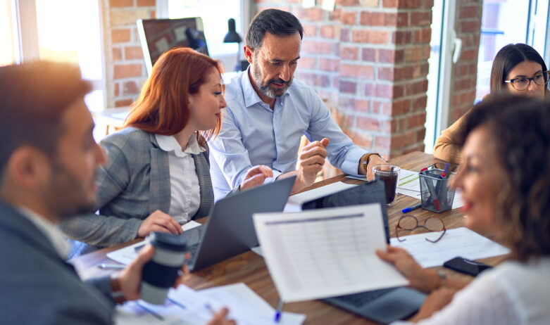 diverse group of business administrators sitting around a table