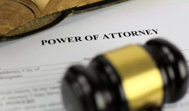 a power of attorney with a gavel on a desk