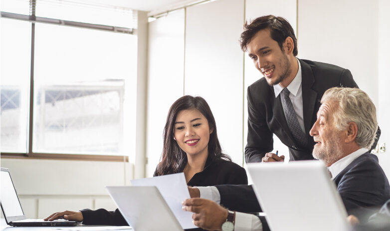 three business professionals reviewing documents at a table