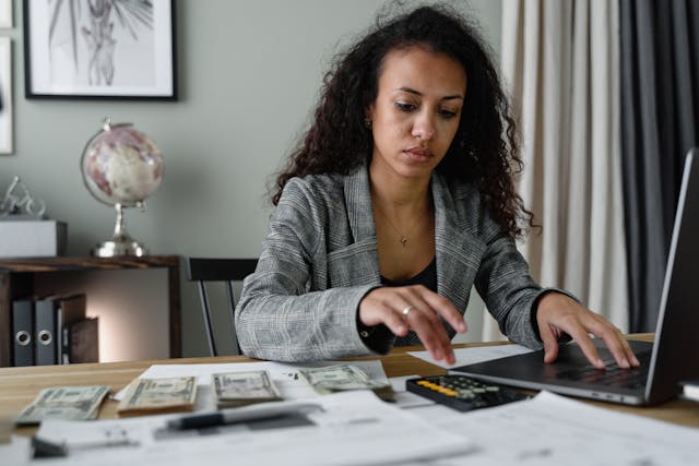 woman managing paperwork and money